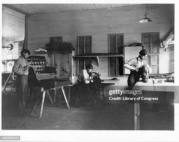 Young North American Indian students build and assemble a carriage in shop class at the Carlisle Indian School, Carlisle, Pennsylvania. | Location:...