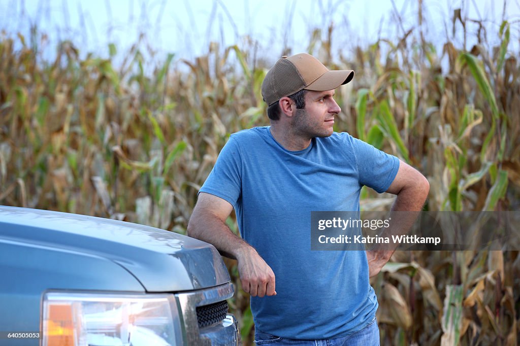Farmer leaning on his truck