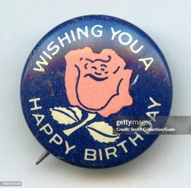 Pinback button with lettering reading "Wishing You a Happy Birthday" and a device featuring a white and pink rose on a blue background, 1950. .