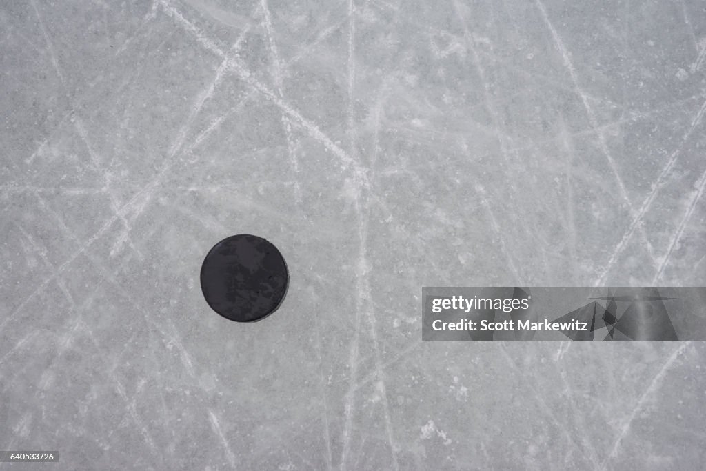 A hockey puck on an ice rink