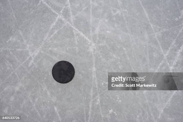 a hockey puck on an ice rink - hockey puck top view stock pictures, royalty-free photos & images