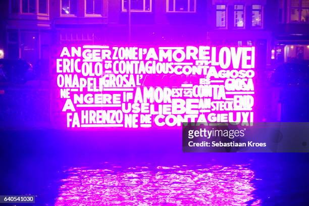 pink bright lit "together" sculpture, amsterdam light festival, the netherlands - amsterdam gracht stockfoto's en -beelden