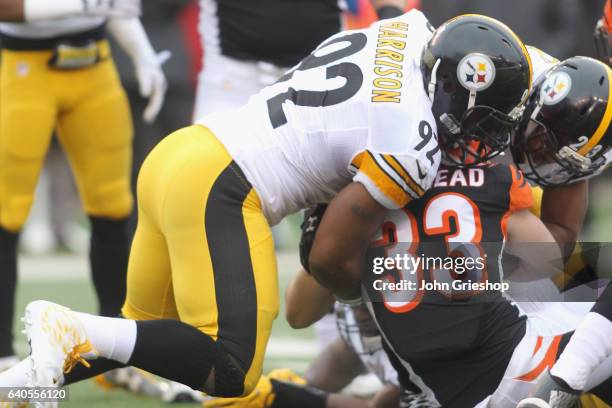 James Harrison of the Pittsburgh Steelers makes the tackle on Rex Burkhead of the Cincinnati Bengals during their game at Paul Brown Stadium on...