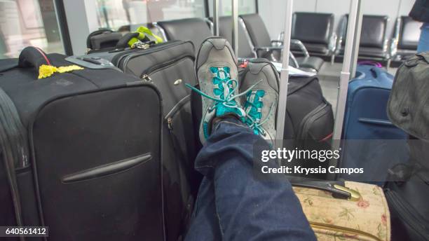 low section of passenger waiting for flight at the airport lounge - business class reclining plane stock pictures, royalty-free photos & images