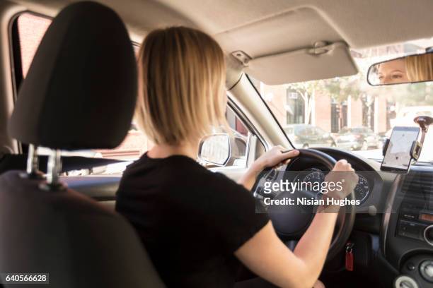 woman driving car - femme de dos smartphone photos et images de collection