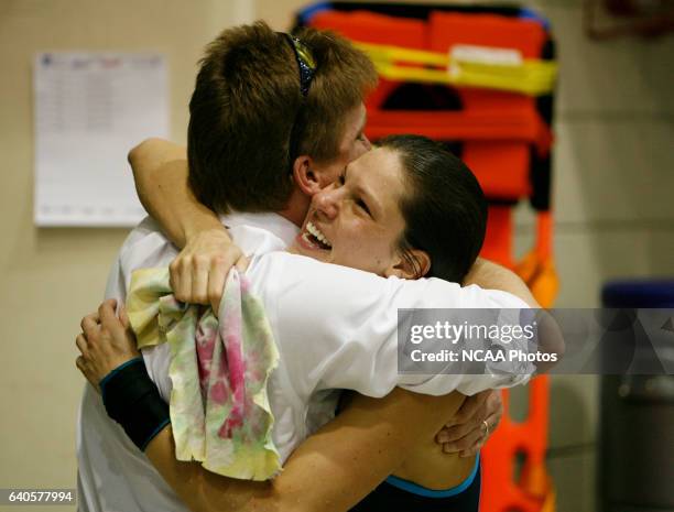 Jamie Wolf from Clarion University is congratuled by her diving coach, Dave Hrovat after competeing in the 3 mtr diving during the Division II...