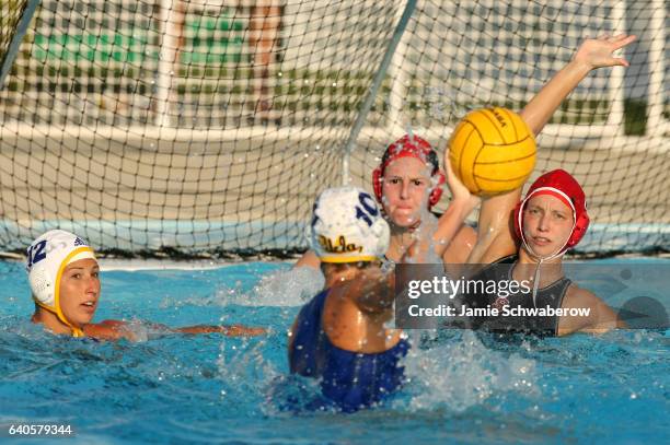 Alison Gregorka and Meridith McColl of Stanford University defend the goal against Kelly Rulon of UCLA during the Division I Women's Water Polo...