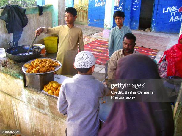 life around the shrine of manghopir - burqa for sale stock pictures, royalty-free photos & images