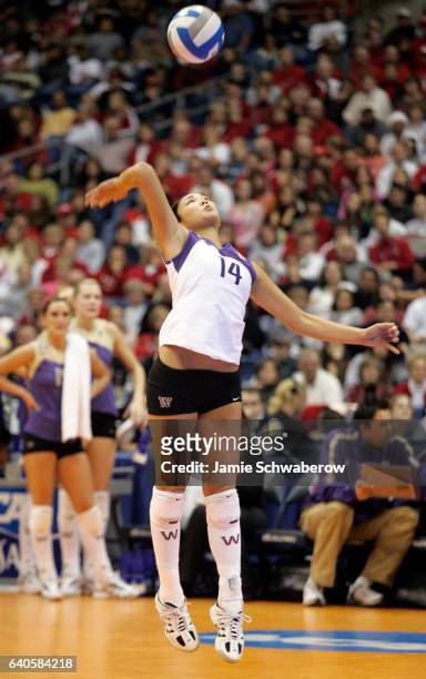 Candace Lee of the University of Washington serves against the University of Nebraska during the Division I Women's Volleyball Championship held at...