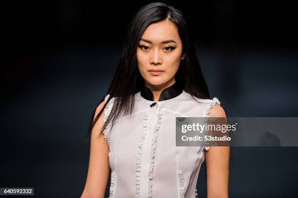 Model showcases designs by Shanghai Tang during the Day 4 of the Hong Kong Fashion Week for Fall / Winter 2015 at the Hong Kong Convention and...