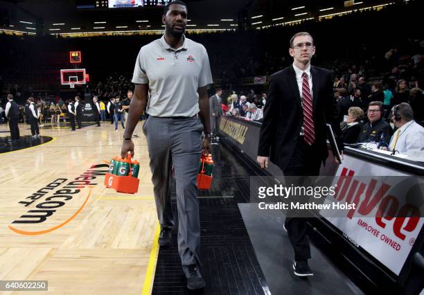 Student manager Greg Oden of the Ohio State Buckeyes carries water bottles off the court following the match-up against the Iowa Hawkeyes, on January...