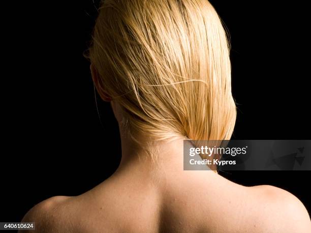 studio shot of young woman's bare back and neck - woman v neck stock pictures, royalty-free photos & images