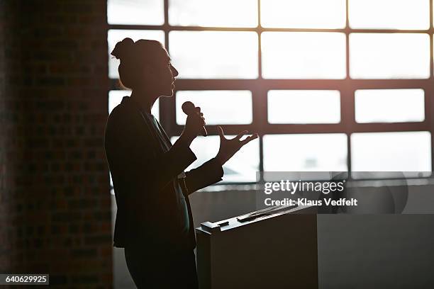 businesswoman doing a lecture in auditorium - announcement fotografías e imágenes de stock