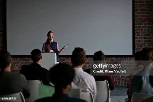 businesswoman doing a talk at convetion - candidate experience stock pictures, royalty-free photos & images