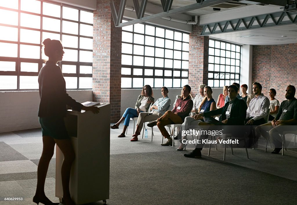 Businesswoman doing presentation in auditorium