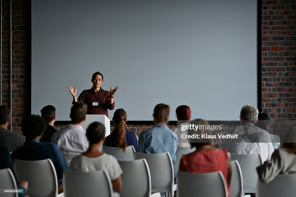 Businessman doing a presentation at big convention