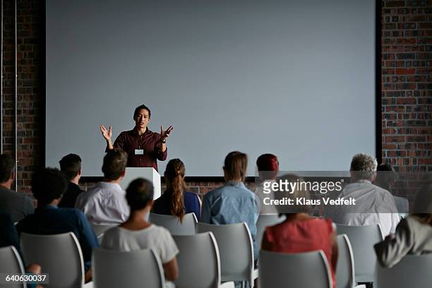 businessman doing a presentation at big convention - speech stock pictures, royalty-free photos & images