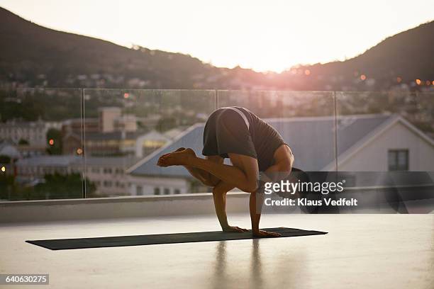 man balancing on hands on yoga mat - asian man barefoot foto e immagini stock