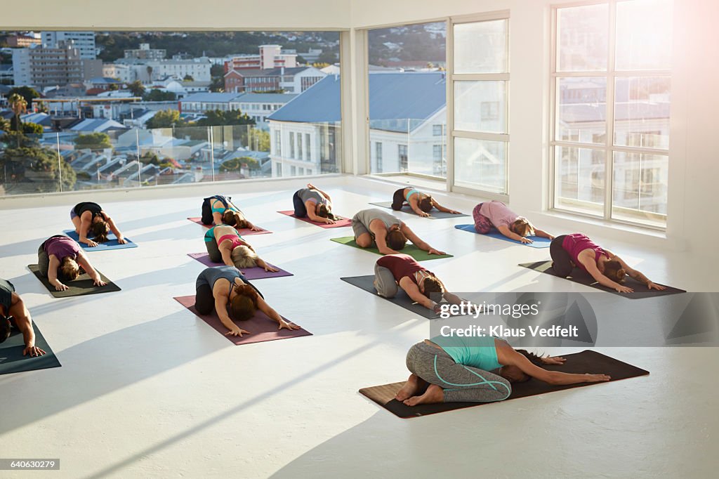 Group of people stretching arms at yoga session