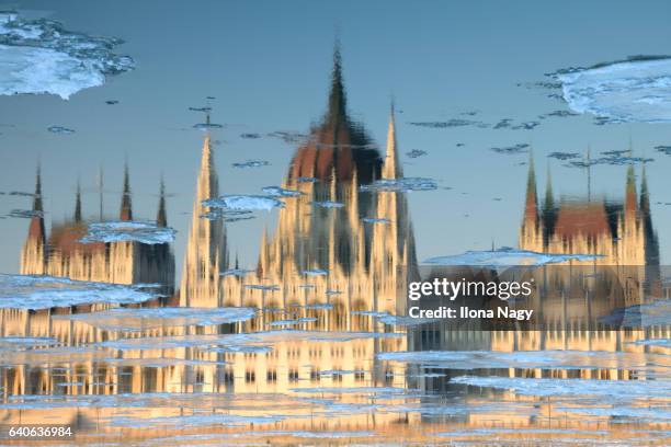 reflection of the hungarian parliament building in winter, budapest, hungary - budapest winter stock pictures, royalty-free photos & images