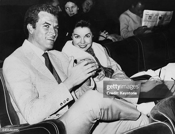 Argentine-born actor and director Fernando Lamas watching a film with his fiancee, actress and swimmer Esther Williams in Rome, 29th January 1962....