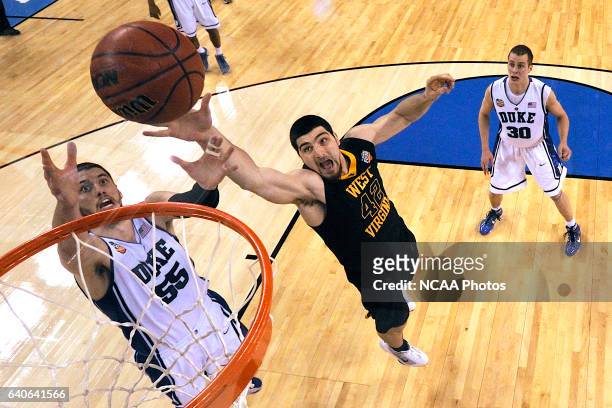 Deniz Kilicli from West Virginia battles for a rebound against Brian Zoubek from Duke during the semi final game of the Men's Final Four Basketball...
