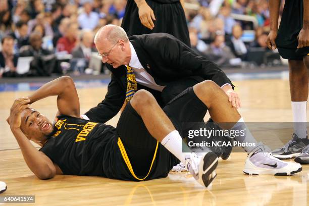 Da' Sean Butler of West Virginia reacts to his knee injury during the semi final game of the Men's Final Four Basketball Championships held at Lucas...