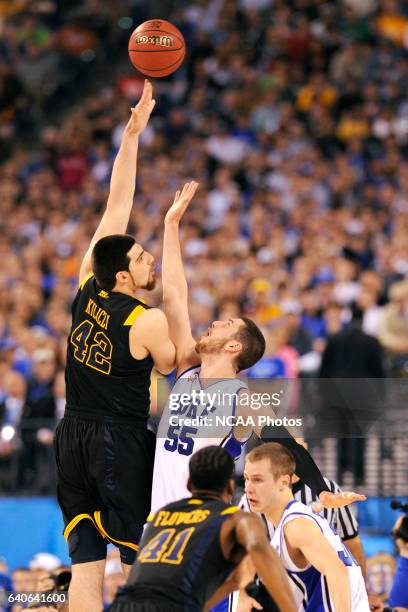 Deniz Kilicli of West Virginia puts up a shot in front of Brian Zoubek of Duke during the semi final game between Duke and West Virginia at the Men's...