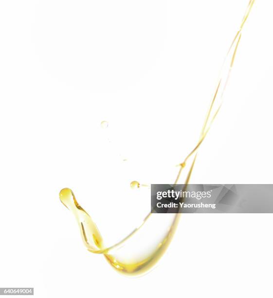 active oil splash in white background - oil drop stock pictures, royalty-free photos & images