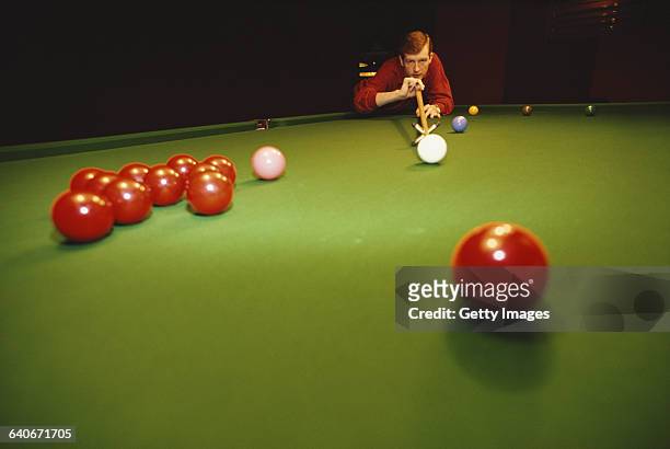 Portrait of snooker world champion Steve Davis of Great Britain as he lines up the cue ball on 1 January 1985 in London, United Kingdom.
