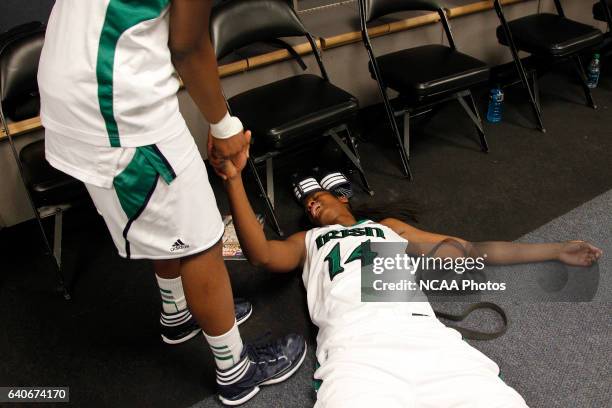 Devereaux Peters of he University of Notre Dame collapses of exhausting in the locker room after defeating the University of Connecticut during the...