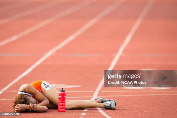 Samantha Edwards of Virginia State University lays on the ground in exhaistion after competing in the Women's 400 Meter Dash during the NCAA Photos...