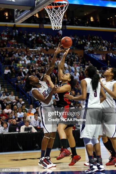 Tina Charles of the University of Connecticut blocks the shot of Monique Reid of the University of Louisville during the Division I Women's...