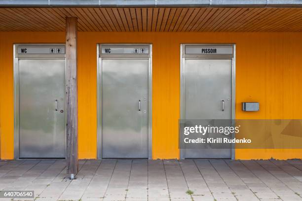 view of public restroom in germany - toilet door stock-fotos und bilder