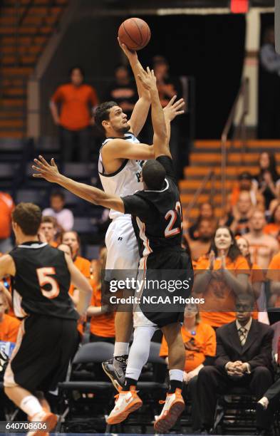 Tobias Jahn of Cal Poly Pomona puts a shot up while Josh Bostic of Findlay jumps to block him during the Division II Men's Basketball Championship...