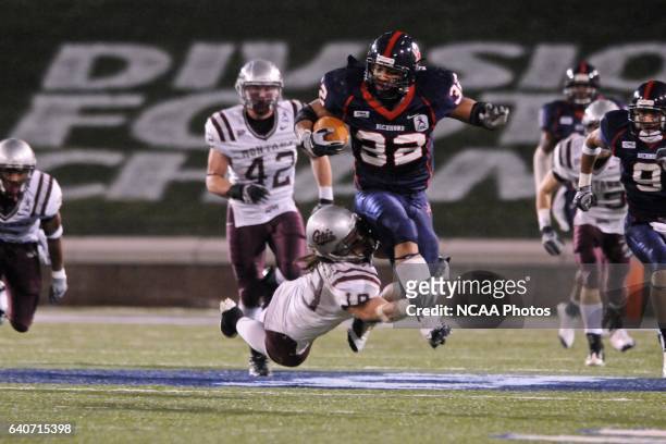 Josh Vaughan of Richmond jumps over Colt Anderson of Montana during the 2008 Division I Men's Football Championship held at Finley Stadium-Davenport...