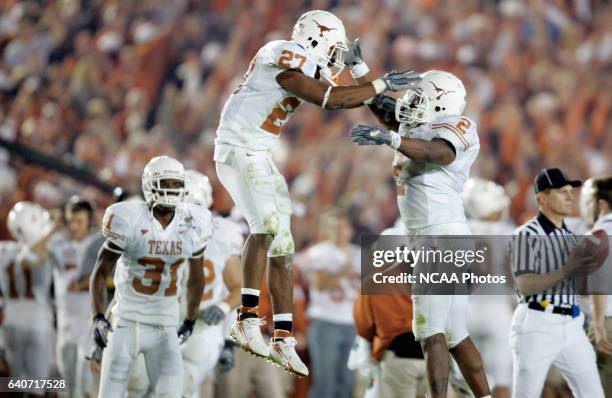 Michael Griffin and Aaron Harris of the University of Texas celebrate Griffin's interception against the University of Southern California during the...