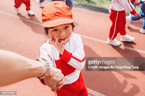 dad holding hands with daughter on sports day - child and unusual angle stock pictures, royalty-free photos & images