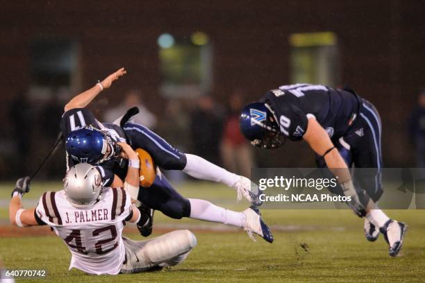 Chris Whitney of Villanova University is sacked by Jace Palmer of the University of Montana during the Division I Men's Football Championship held at...