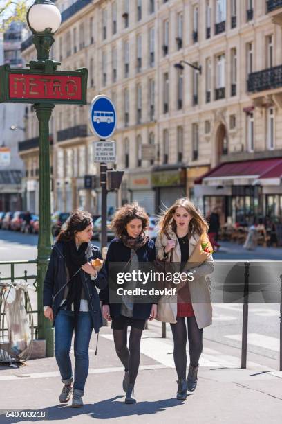 group of young women friends walking in paris - subway paris stock pictures, royalty-free photos & images