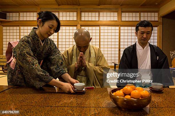 Buddhist monk KÃ¸han Kamata, 56 and Masatsugo Okutani, 41 enjoy a green tea inside the Buddhist temple which lies side by side with the Yabuhara...