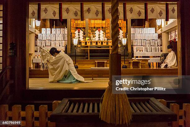 Kazufumi Okutani, 71 and Masatsugo Okutani 41, are the 24th and 25th generational SHINTO "officiants" - priests - in their family line dating back to...