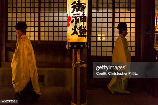 Kazufumi Okutani, 71 and Masatsugo Okutani 41, are the 24th and 25th generational SHINTO "officiants" - priests - in their family line dating back to...