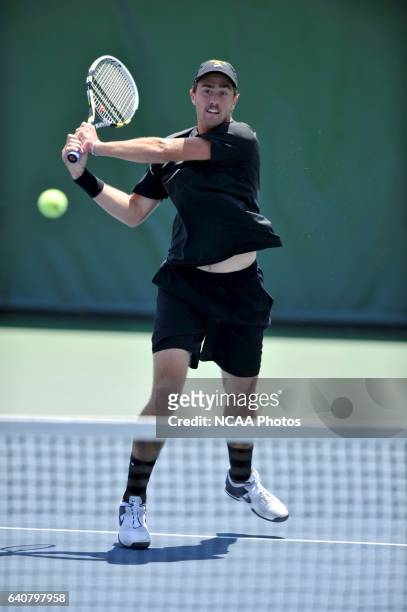 Steve Johnson of the University of Southern California hits the ball against the University of Virginia during doubles play at the Division I Men's...