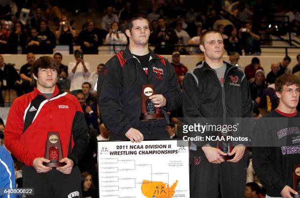 Aaron Denson of Nebraska-Omaha on the podium with his award after defeating Charlie Pipher of Western State during the Division II Men's Wrestling...