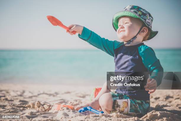 baby boy playing on tropical beach, cayo coco, cuba - baby suncream stock pictures, royalty-free photos & images