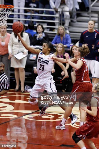 University of Connecticut forward Maya Moore drives past Stanford University guard Jeanette Pohlen to score a layup during the Division I Women's...