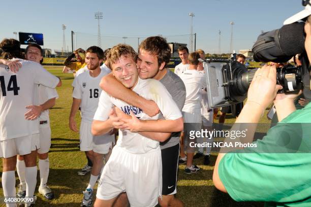 Teammates embrace Geoff Pezon of Messiah College after his go ahead goal against Lynchburg College during the Division III Men's Soccer Championship...