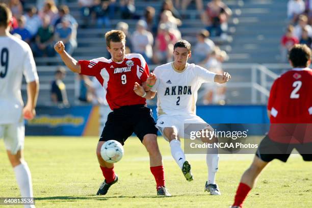Zarek Valentin of the University of Akron and Colin Rolfe of the University of Louisville battle for the ball during the Division I Men's Soccer...