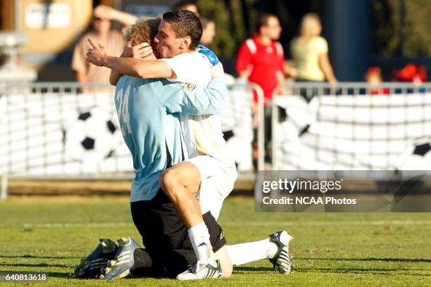 Zarek Valentin of the University of Akron embraces goalie David Meves after their victory over the University of Louisville during the Division I...
